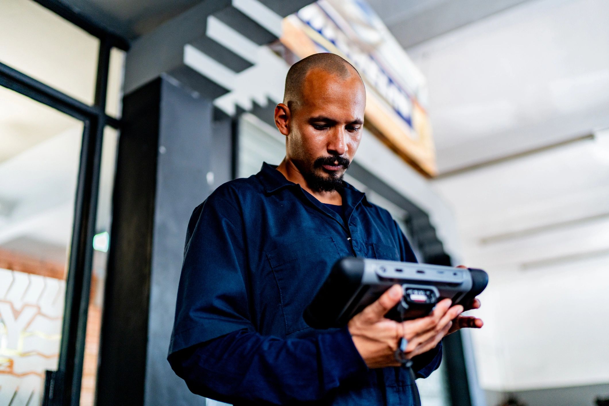 Automotive technician in Kenya using a diagnostic scanner for ECU/TCU programming